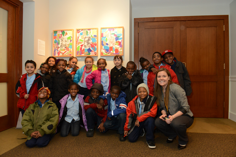 Ms. Frey’s first grade class from Takoma Education Campus in front of their artwork 