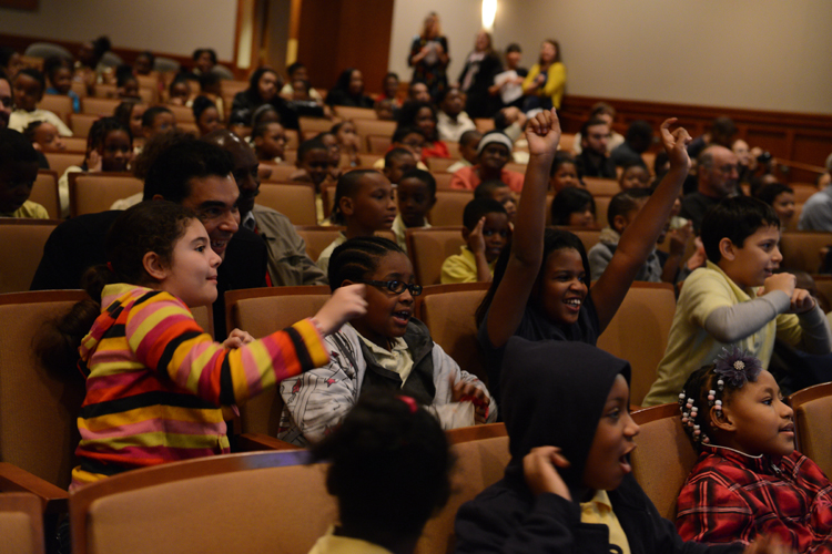Tyler students cheer on their teachers in the auditorium at the Artists Reception