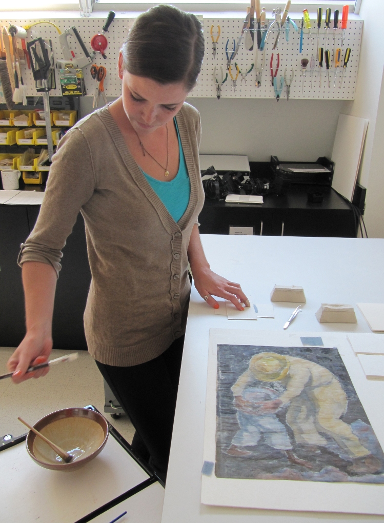 Step 2: Conservation technician, Caroline Hoover, prepares the hinges and wheat starch paste for the new mount