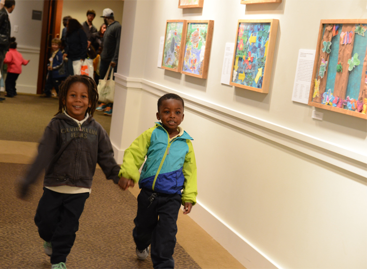 Tyler Elementary School students peruse the Young Artists Exhibition featuring their class's collaborative artwork. Photo: James R. Brantley