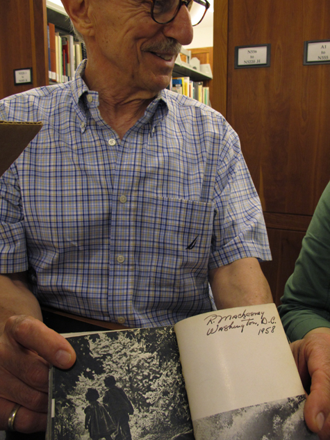 Raymond shows his inscribed copy of The Family of Man, purchased in D.C. in 1958.