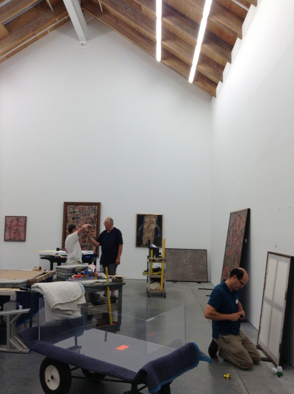 Angels, Demons, and Savages: Pollock, Ossorio, Dubuffet” being installed