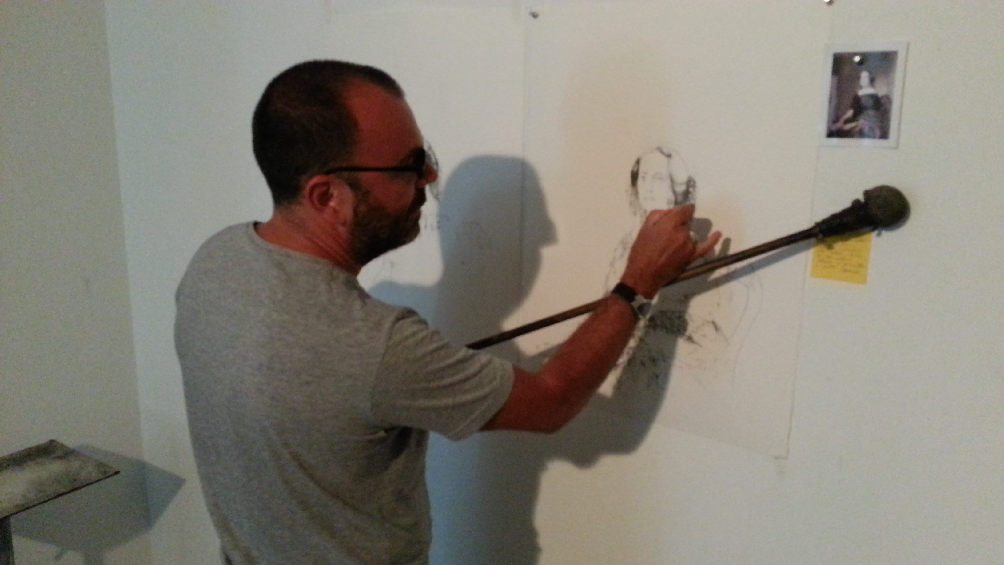 Roig creates a drawing using a hand-made implement to steady his hand during the elaborate sketching.