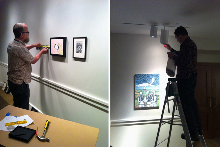 Phillips preparators install works of art for the staff show and adjust lighting. 