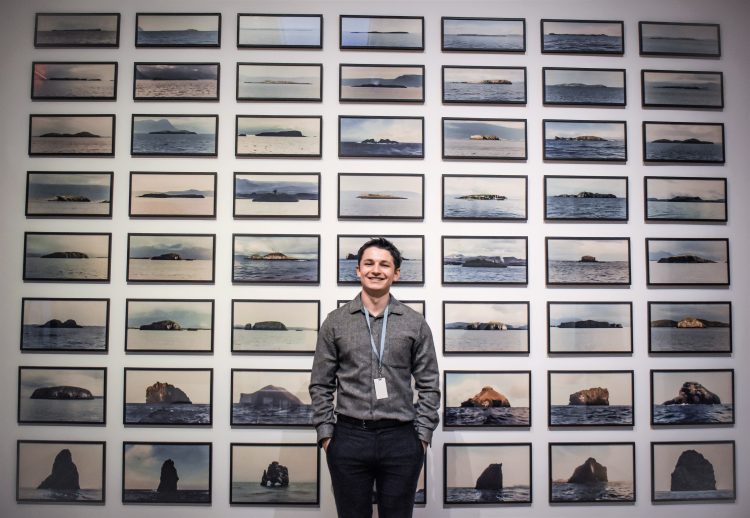 Jonah Conlin, photographed by Kabrea Hayman in front of Olafur Eliasson's "The Island Series" in Nordic Impressions: Art from Åland, Denmark, the Faroe Islands, Finland, Greenland, Iceland, Norway, and Sweden, 1821–2018